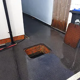 a manhole hole in the floor of a building