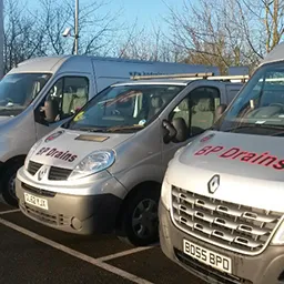 a row of vans parked in a parking lot